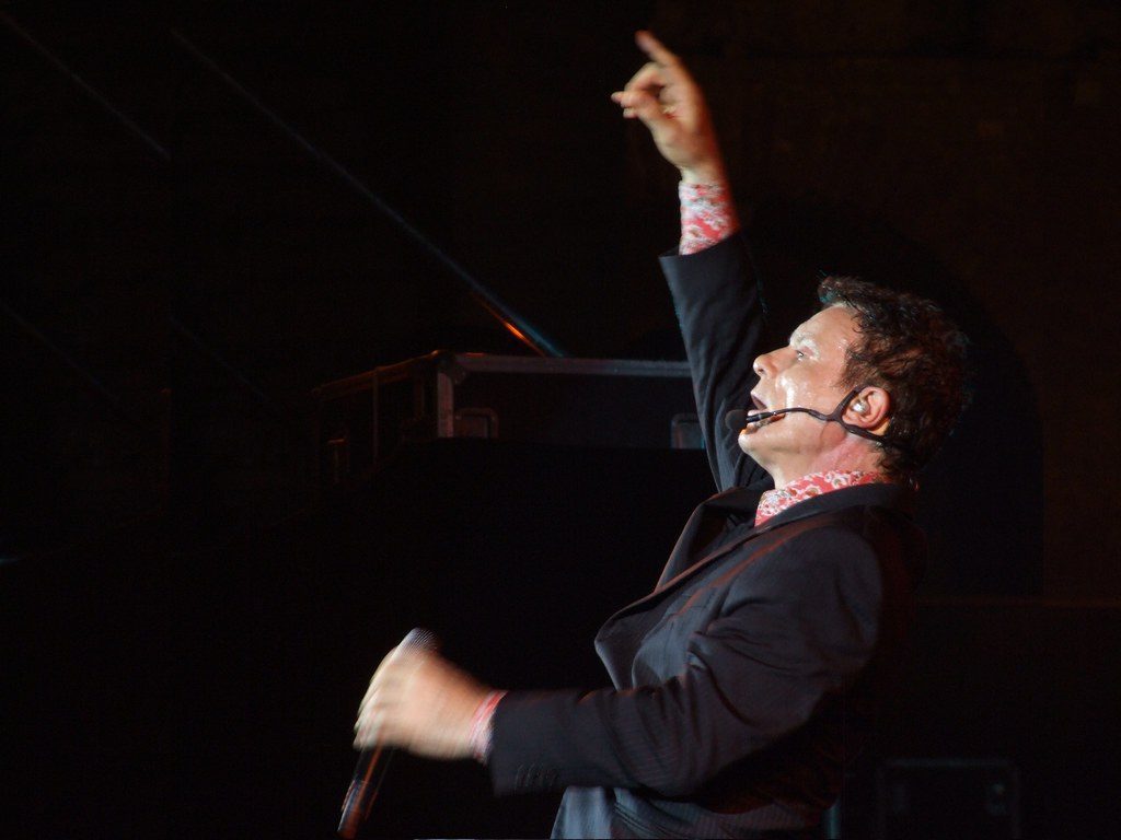 Musicians performing on a lit stage